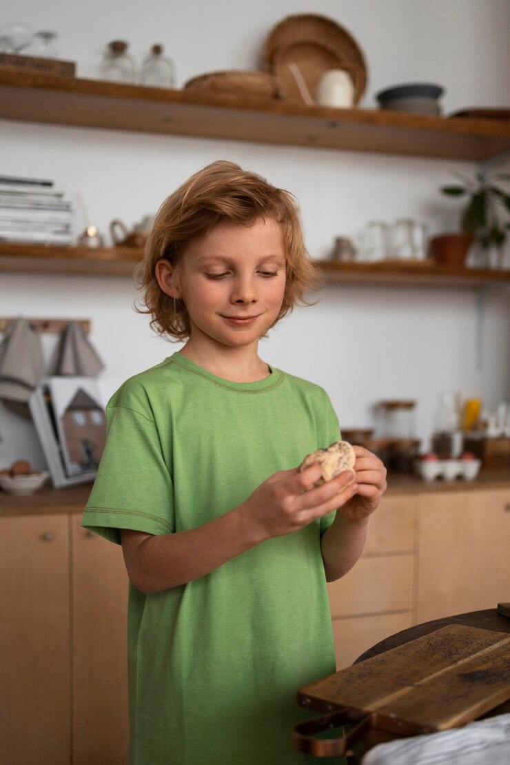 Free Photo medium shot kid preparing food