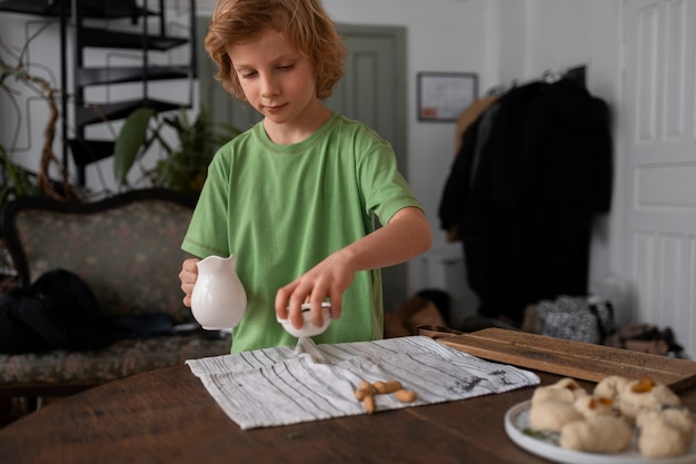 Free photo medium shot kid preparing food