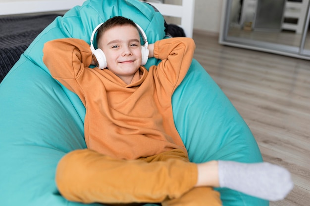 Medium shot kid sitting on bean bag chair