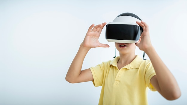 Medium shot kid wearing vr glasses