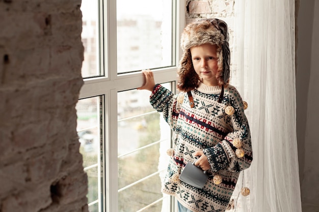 Medium shot kid with hat and mug posing