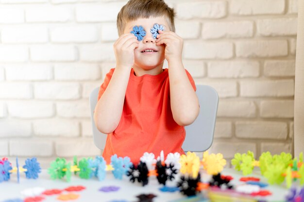 Medium shot kid with plastic snowflakes