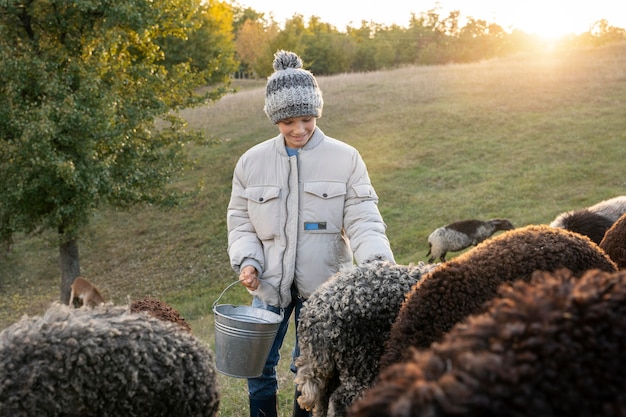 Free photo medium shot kid with sheep