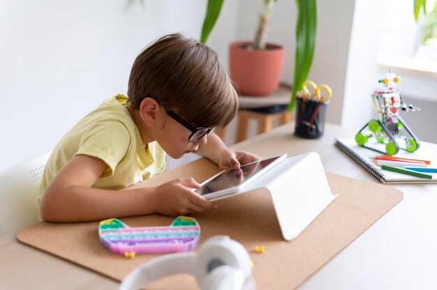 Medium shot kid with tablet