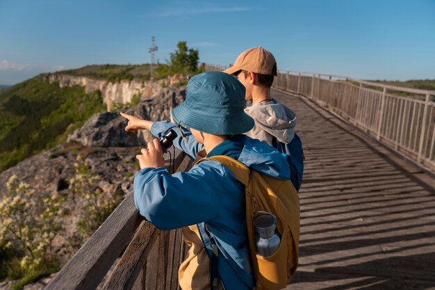 Medium shot kids exploring natural environment