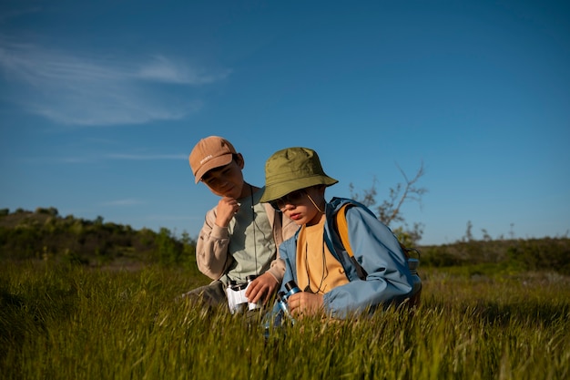 Free photo medium shot kids exploring natural environment