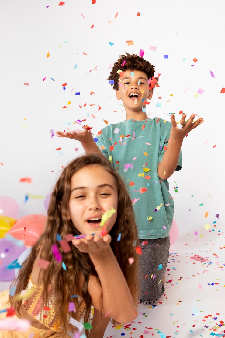 Free Photo medium shot kids having fun with confetti