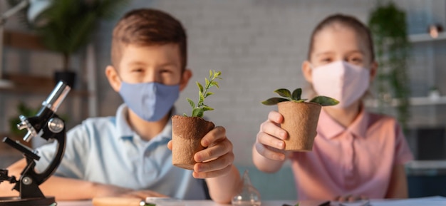 Medium shot kids holding plant pots