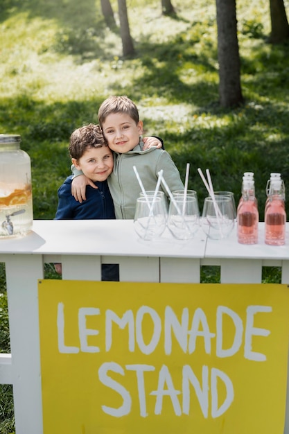 Free photo medium shot kids hugging outdoors