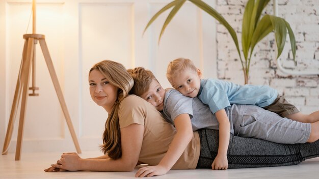 Medium shot kids laying on woman