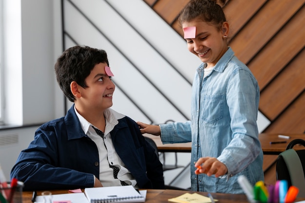 Foto gratuita bambini di tiro medio che imparano a scuola