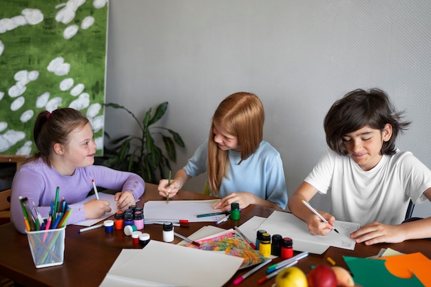 Medium shot kids painting indoors