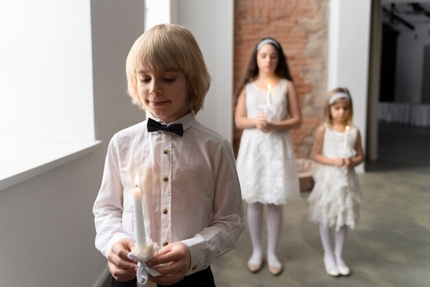 Medium shot kids praying indoors