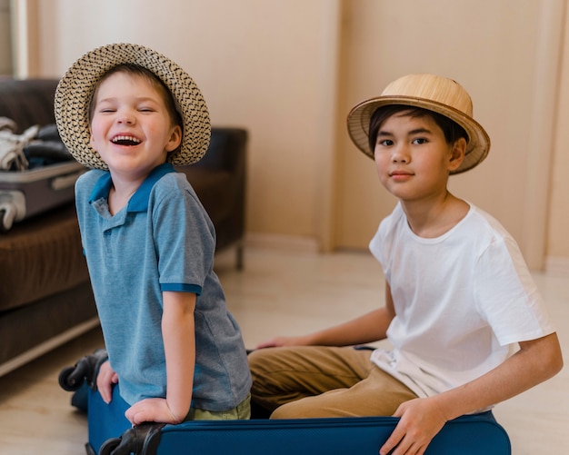 Medium shot kids sitting in baggage