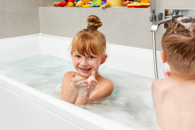 Medium shot kids sitting in the bathtub