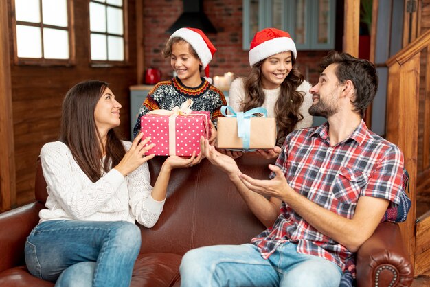 Medium shot kids surprising parents with gifts