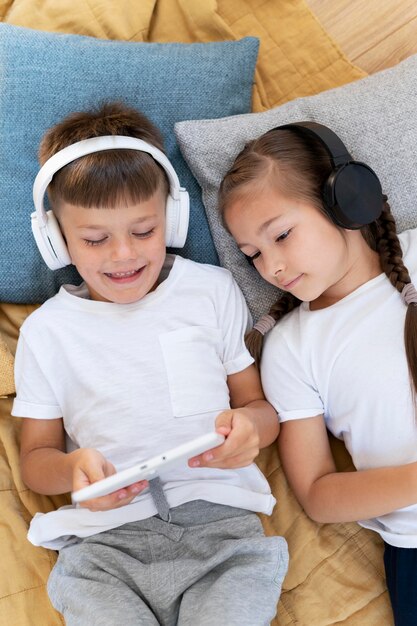 Medium shot kids with laptop and headphones