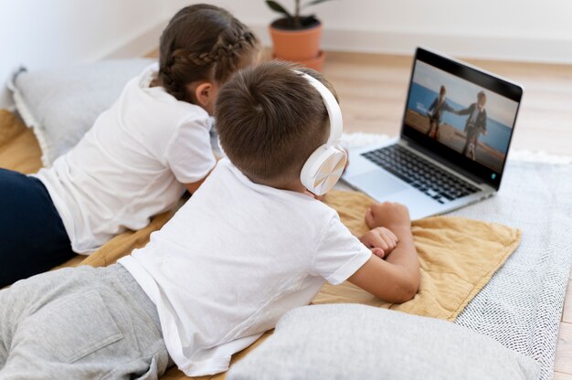 Medium shot kids with laptop indoors