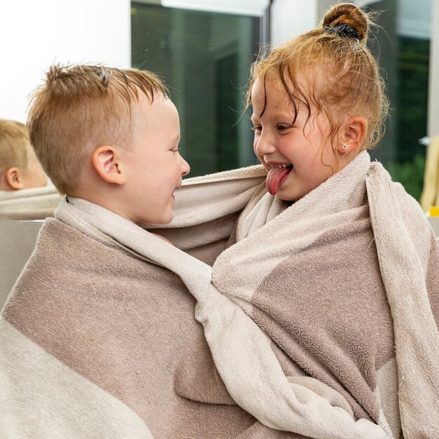 Medium shot kids with towel indoors