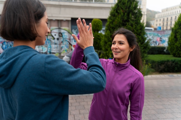 Medium shot latin people training outdoors