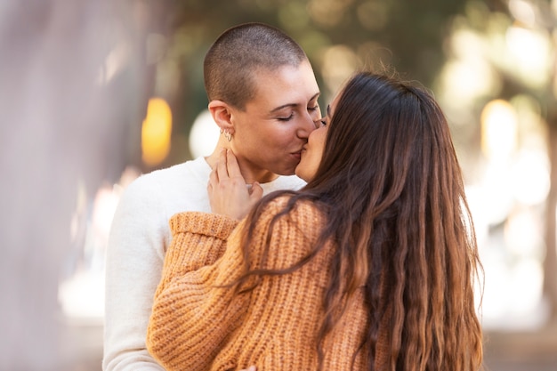 Medium shot lesbian couple kissing