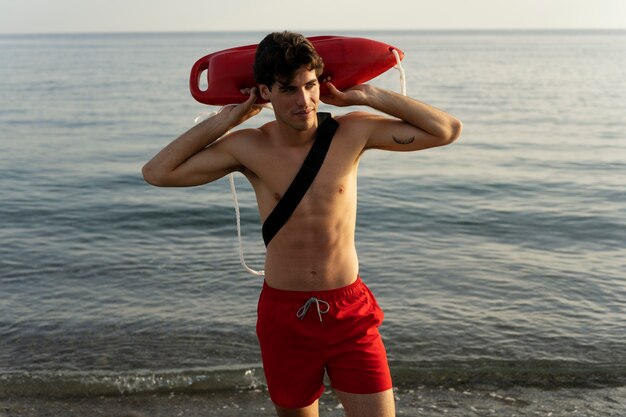 Medium shot lifeguard holding lifesaving buoy