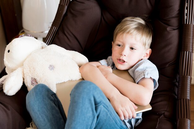 Medium shot little boy holding device