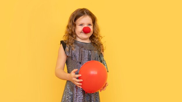 Medium shot little girl wearing clown nose