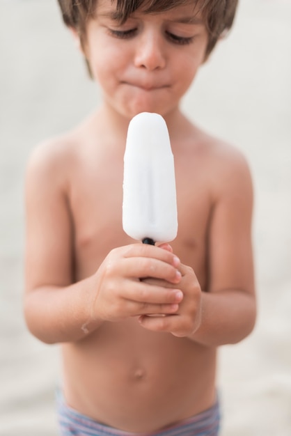 Medium shot of a little kid holding an ice cream