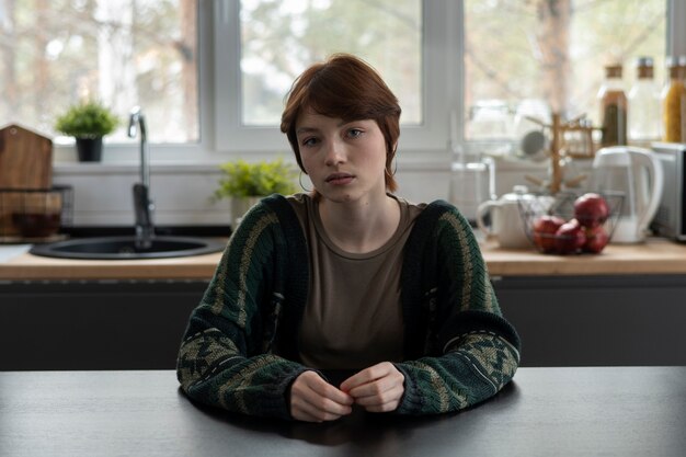 medium shot lonely young woman at table