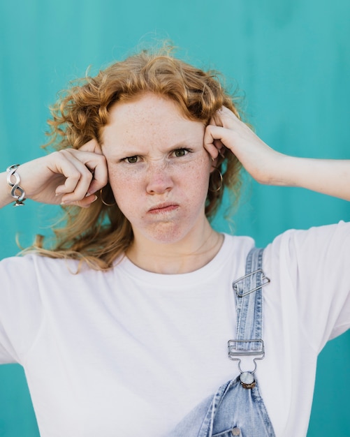 Medium shot mad woman posing with blue background