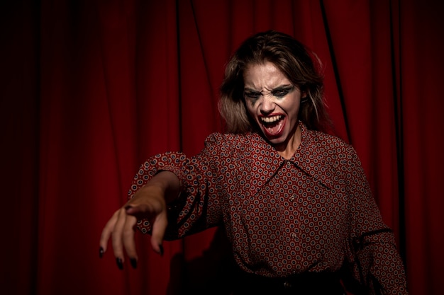 Medium shot of make-up woman clown pointing with her finger