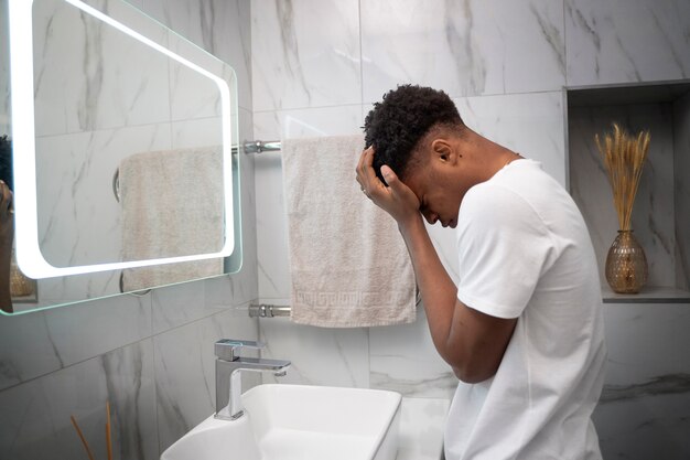 Medium shot man in bathroom feeling betrayed