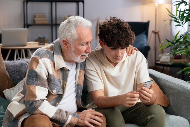 Medium shot man and boy on couch