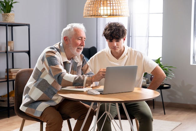 Medium shot man and boy sitting at table