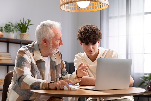 Medium shot man and boy with laptop