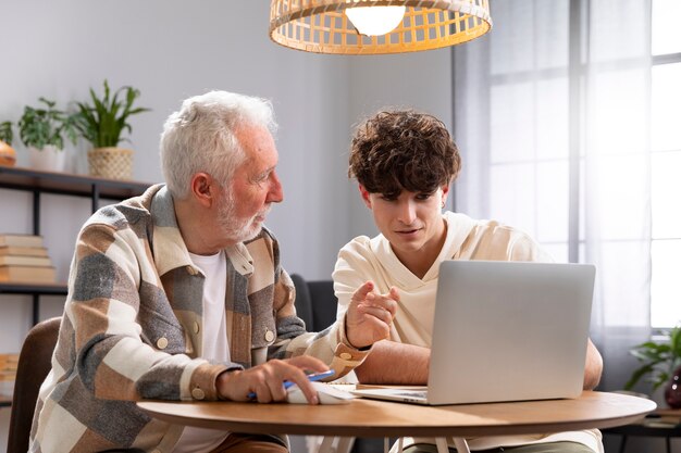 medium shot man and boy with laptop