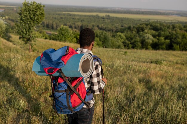 Medium shot man carrying backpack