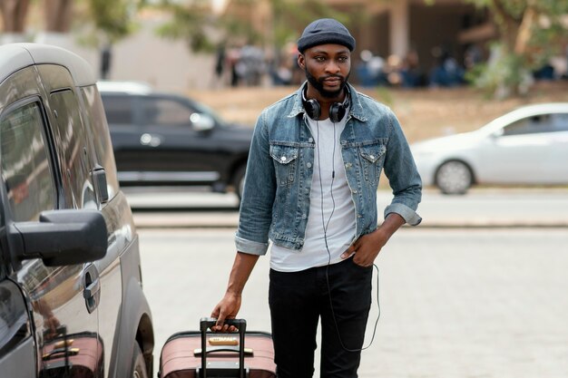 Medium shot man carrying baggage