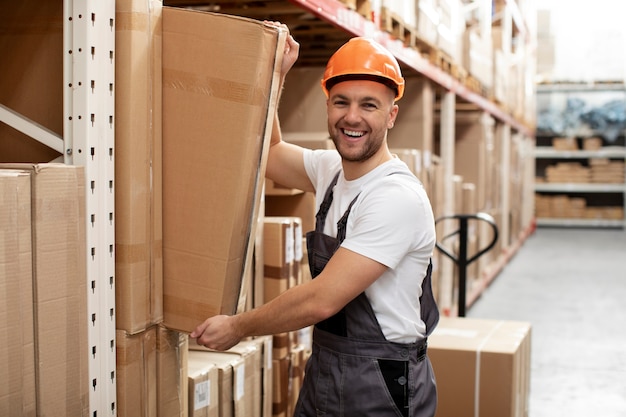 Free photo medium shot man carrying box