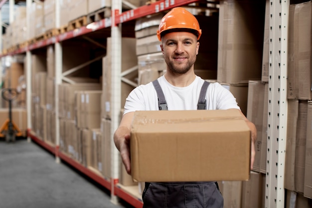 Free photo medium shot man carrying box