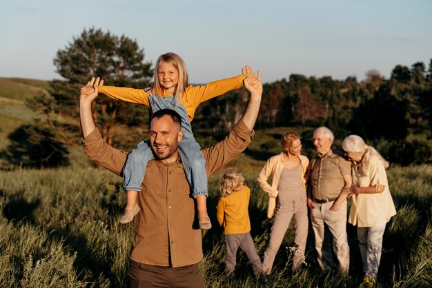 Medium shot man carrying daughter