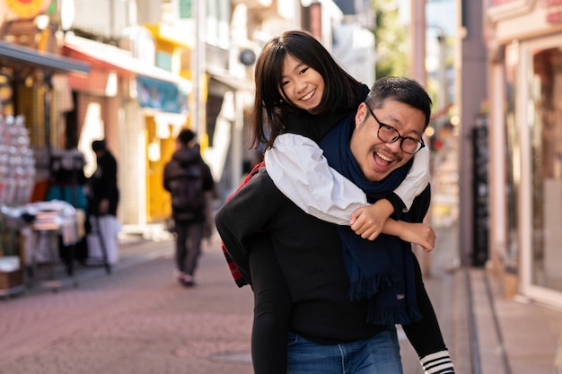 Free photo medium shot man carrying daughter