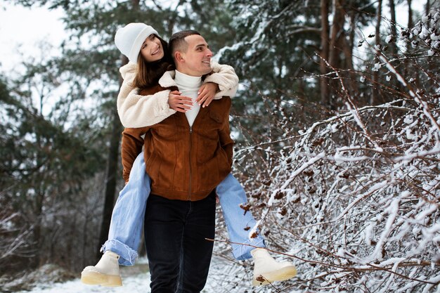 Medium shot man carrying girlfriend