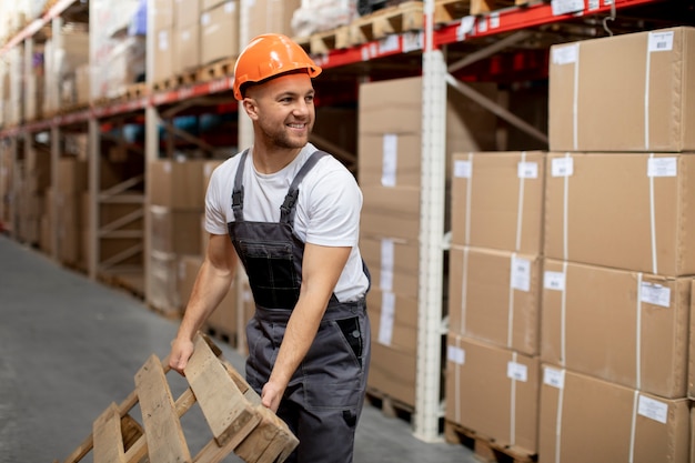 Free photo medium shot man carrying wooden item