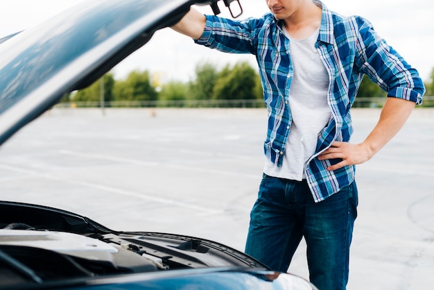 Medium shot of man checking engine