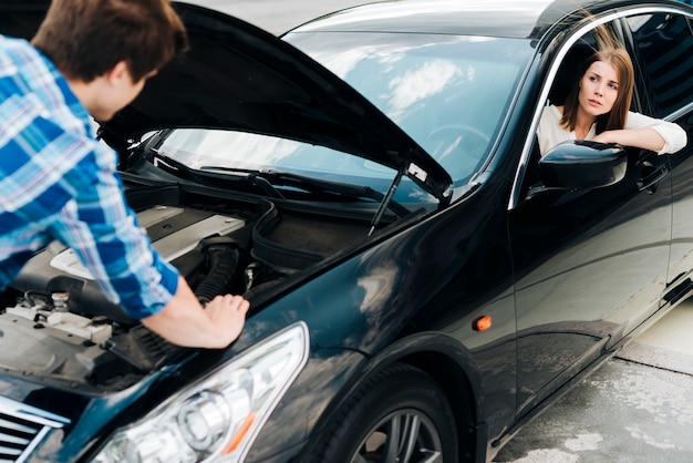 Medium shot of man checking engine