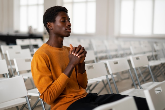 Free photo medium shot man at church praying