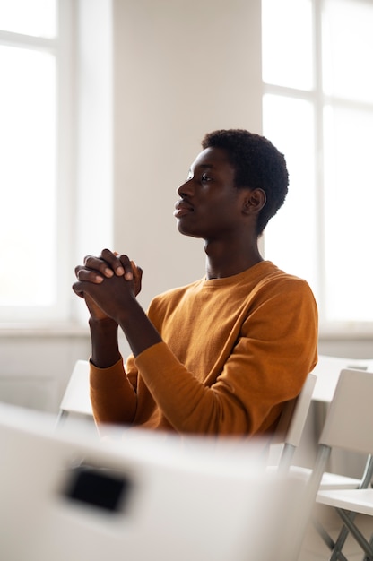 Free photo medium shot man at church praying