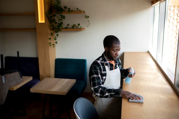 Free photo medium shot man cleaning surface